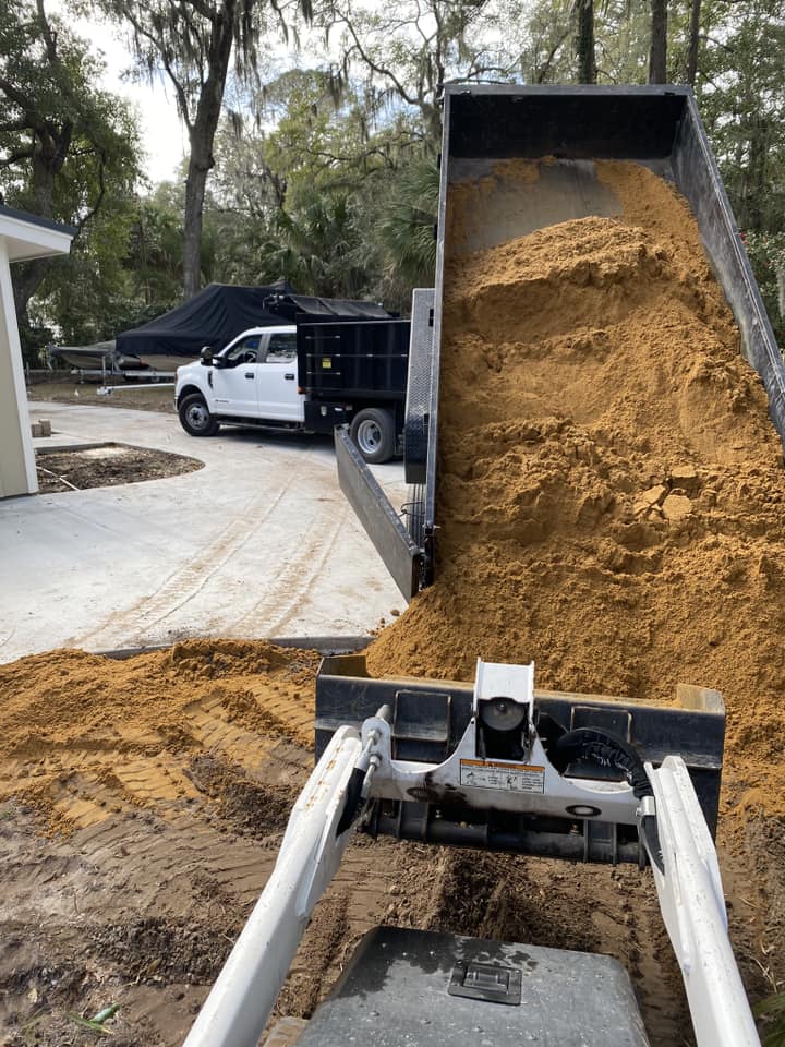 Truck pouring dirt for irrigation