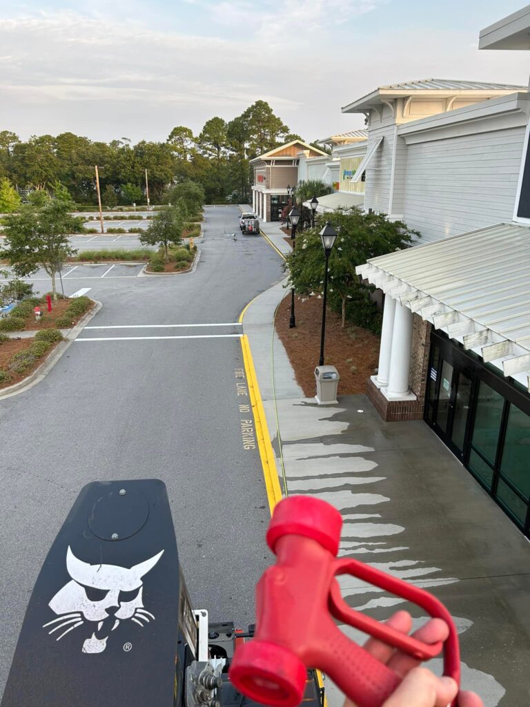 Commercial pressure washing in the Lowcountry. View of parking lot and shopping center.