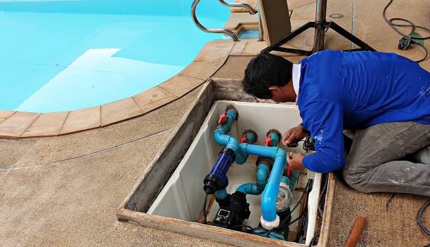 Pool equipment being repaired by a technician