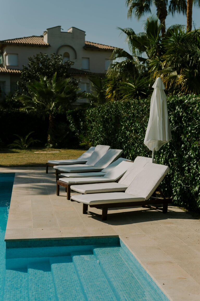 Lounge sun chairs placed poolside